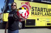 Mike Binko, CEI Advisory Board member poses in front of the Startup Maryland bus.