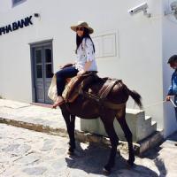 Kate Ford poses on a donkey in Greece.